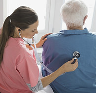 Home Nurse Examining Patient