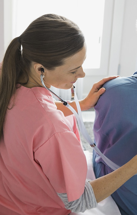 Home Nurse Examining Patient