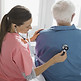 Nurse checking patient's back