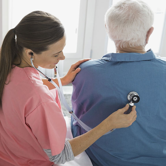 Home Nurse Examining Patient