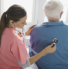Home Nurse Examining Patient