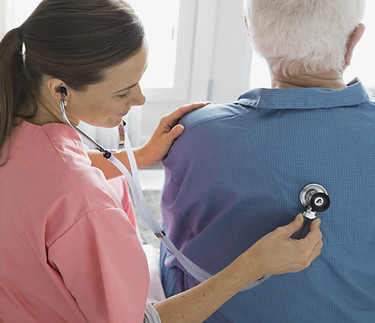 Nurse checking patient's back