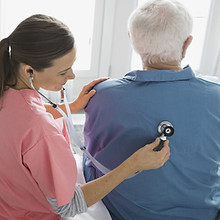 Home Nurse Examining Patient