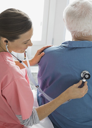 Home Nurse Examining Patient