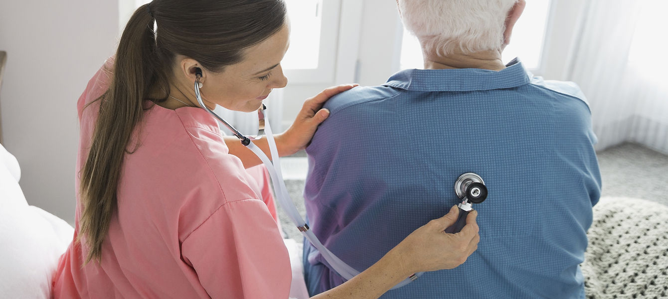 Home Nurse Examining Patient