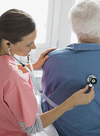 Home Nurse Examining Patient