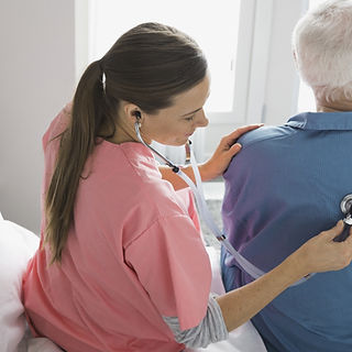 Home Nurse Examining Patient