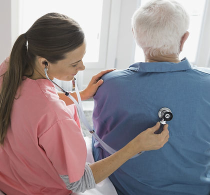 Home Nurse Examining Patient