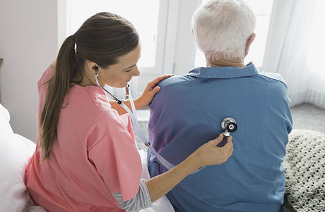 Home Nurse Examining Patient