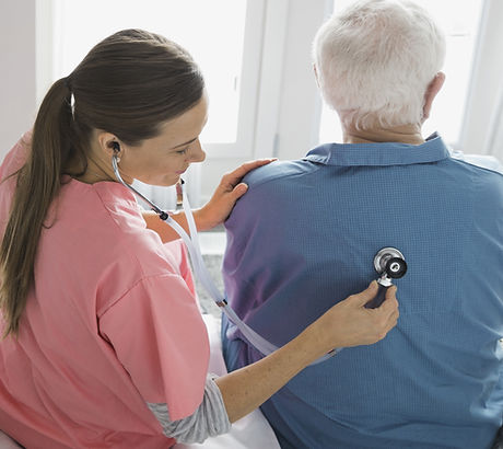 Home Nurse Examining Patient