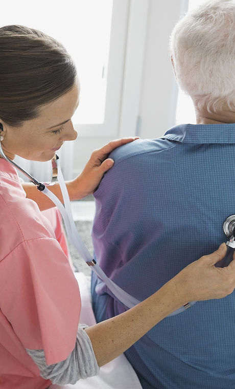 Home Nurse Examining Patient
