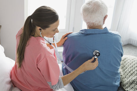 Nurse Checking Patients back