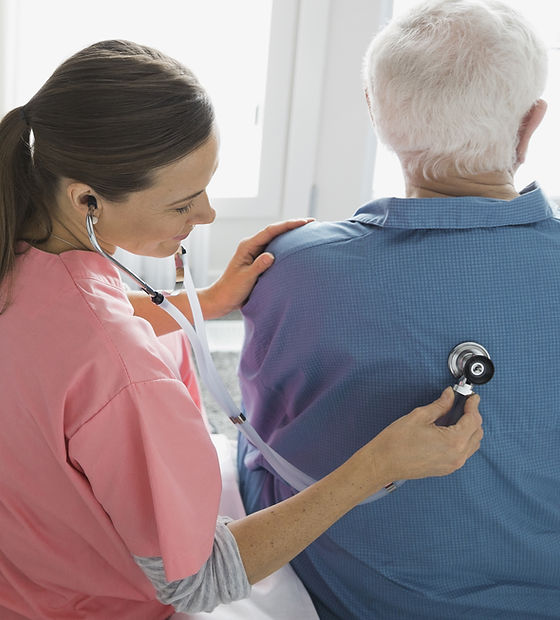 Home Nurse Examining Patient
