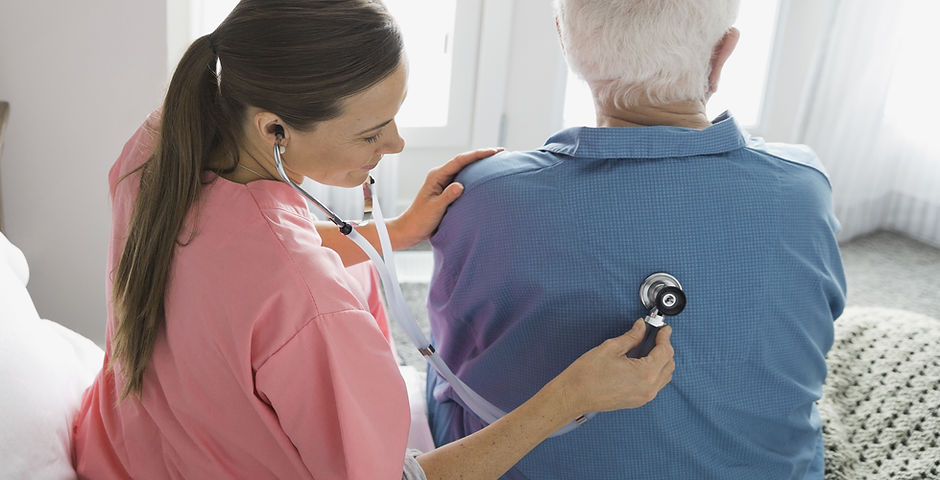 Home Nurse Examining Patient