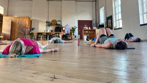 Students in savasana in Pose Fitness studios