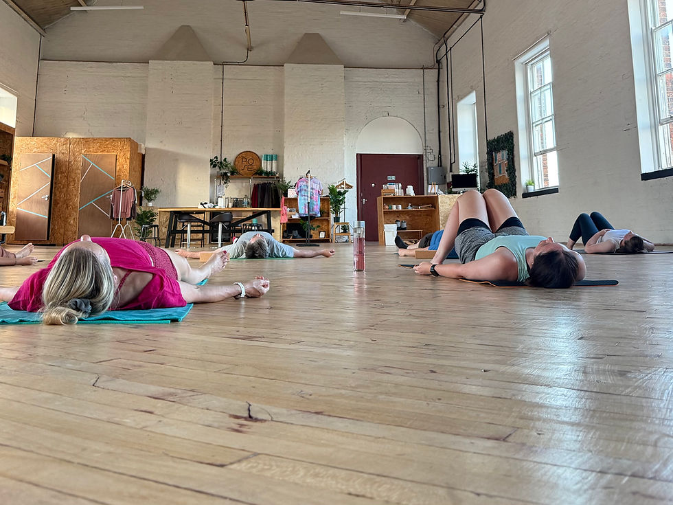 Students in savasana in Pose Fitness studios