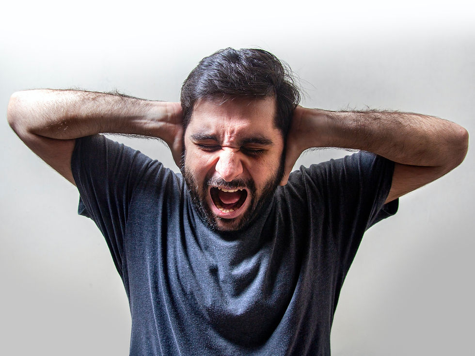 stressed man shouting and holding his head