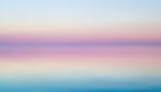 Gently ripping water in forefront of image with above blue and purple sky being reflected in water