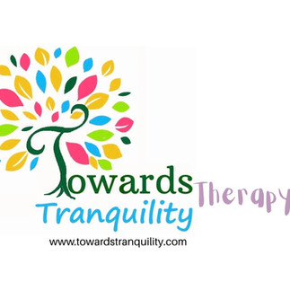 Towards Tranquility Therapy Logo which is a multi coloured tree with words towards tranquility therapy in soft pastel writing