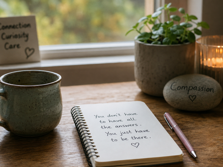 Therapist desk with notebook, calming mug and compassion reminder for working confidently with clinical risk.