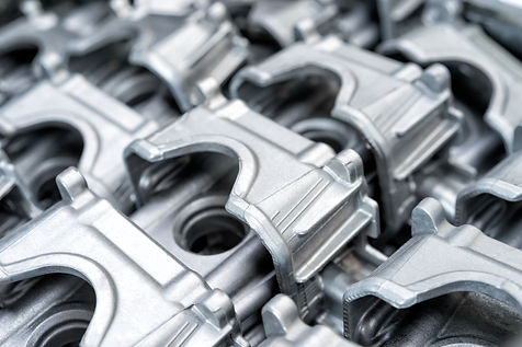 Pile of aluminum automotive parts head cylinder, casting process in the automotive industry factory.