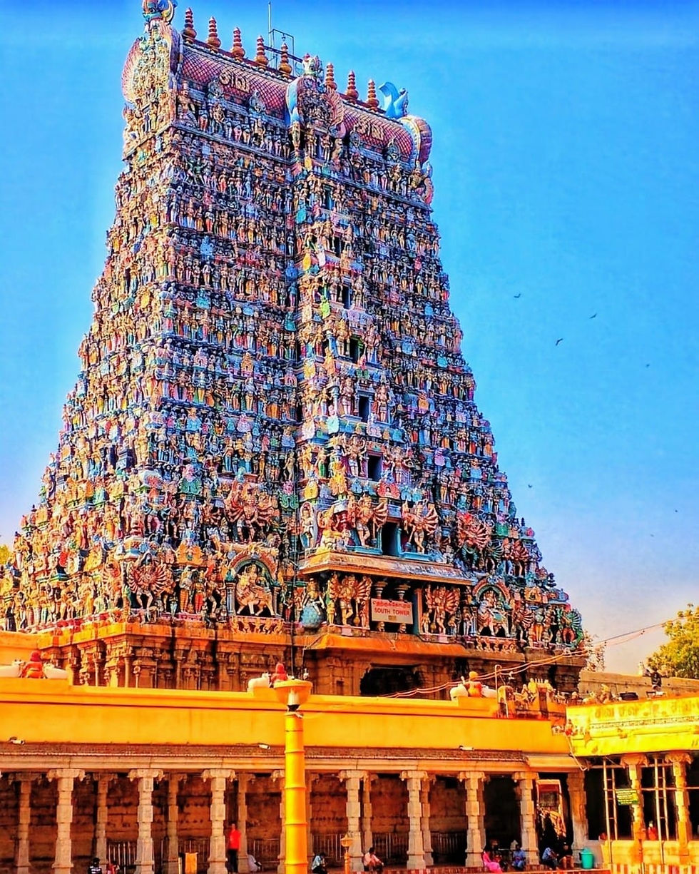 The towering, colorful, and intricately sculpted southern gopuram of the Meenakshi Amman Temple in Madurai, Tamil Nadu, showcasing stunning Dravidian architecture.