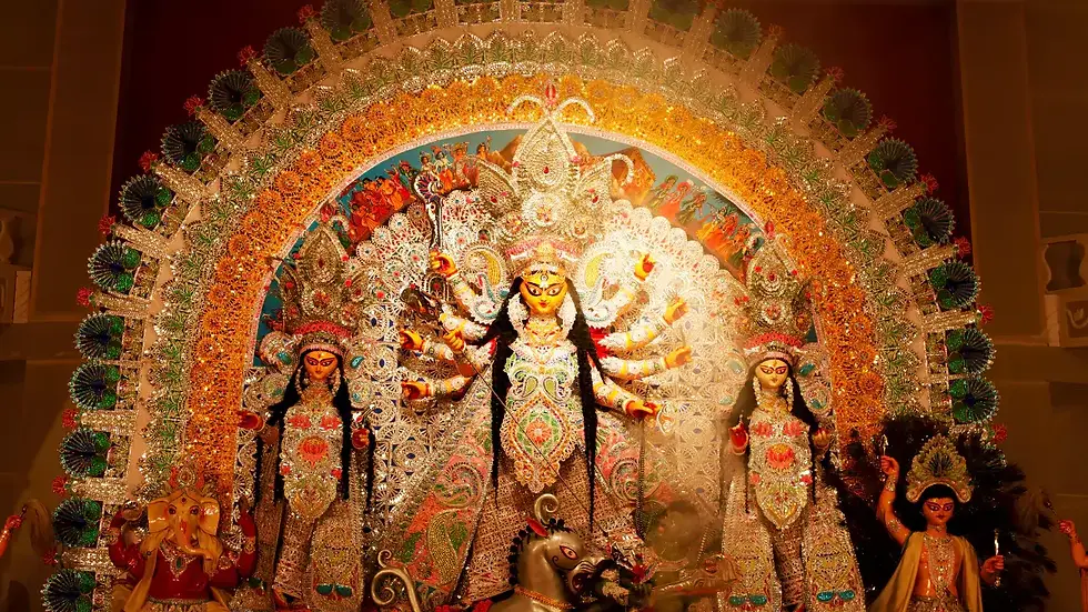 A beautifully decorated Durga Puja idol in Kolkata, depicting Goddess Durga slaying Mahishasura, surrounded by intricate ornamentation and shimmering lights during the Navratri festival.