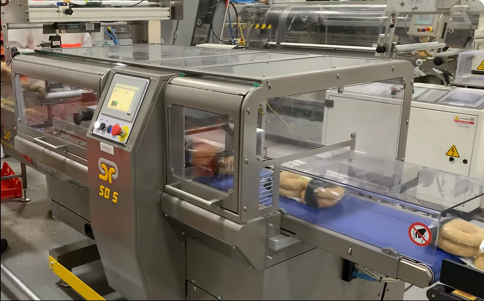 Real production photo of a GSP 50s flow wrapper installed and commissioned by PacMatix, packaging four-pack bagels in a customer manufacturing facility.