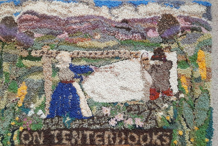 Rag rug depicting a scene from the Kendal wool industry of a man and woman pegging wool cloth onto tenterhooks in a field.