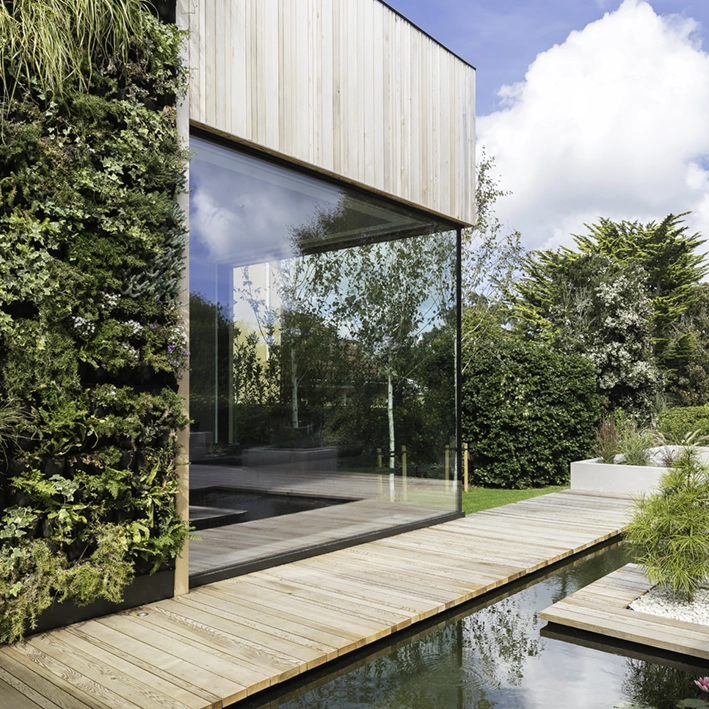  Image of the Bohemia house featuring a vertical garden wall, highlighting how DLM Architects integrate green spaces into their designs.