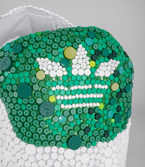 Closeup of the Adidas logo on the large sculpture of the Adidas Stan Smith sneaker made entirely out of recycled bottle caps as a celebration of community and working towards a sustainable future.