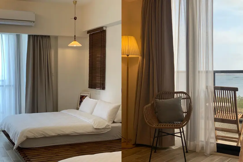 木艮私宅，臥室內有一張白色床，棕色百葉窗，吊燈；客廳有藤椅和落地燈，窗外為海景，整體風格簡約舒適。