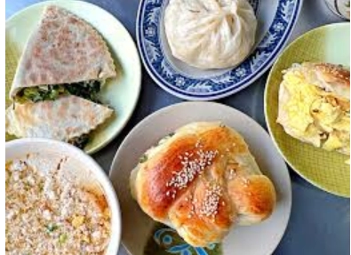 孟記早點，盤中有多種早餐，包括包子、餡餅、雞蛋捲和撒有芝麻的蔥餅。