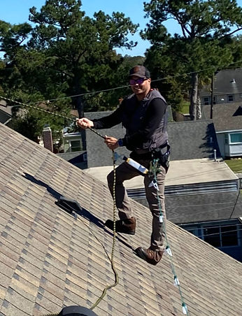 Kody repelling on a roof so you don't have to