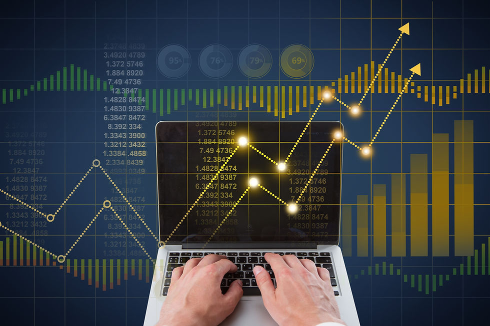 Hands typing on a laptop over glowing financial charts, graphs and upward arrows on a dark blue data screen.