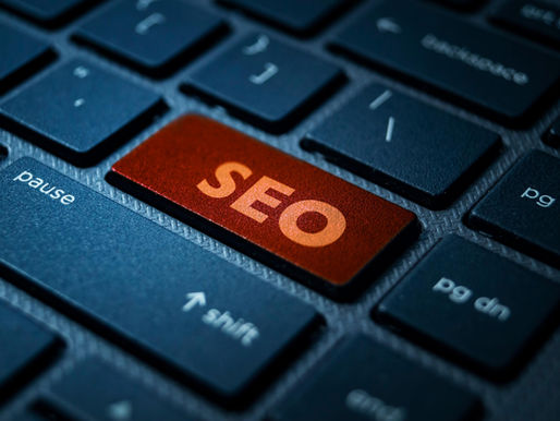 Close-up of a keyboard with a red key labeled "SEO" replacing "Enter" key, surrounded by black keys.