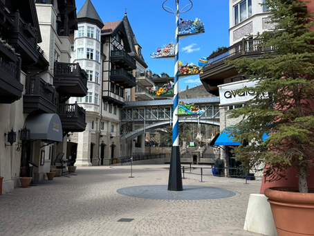 Vail Village featuring shops, lodges and trees. Mood is welcoming and scenic.