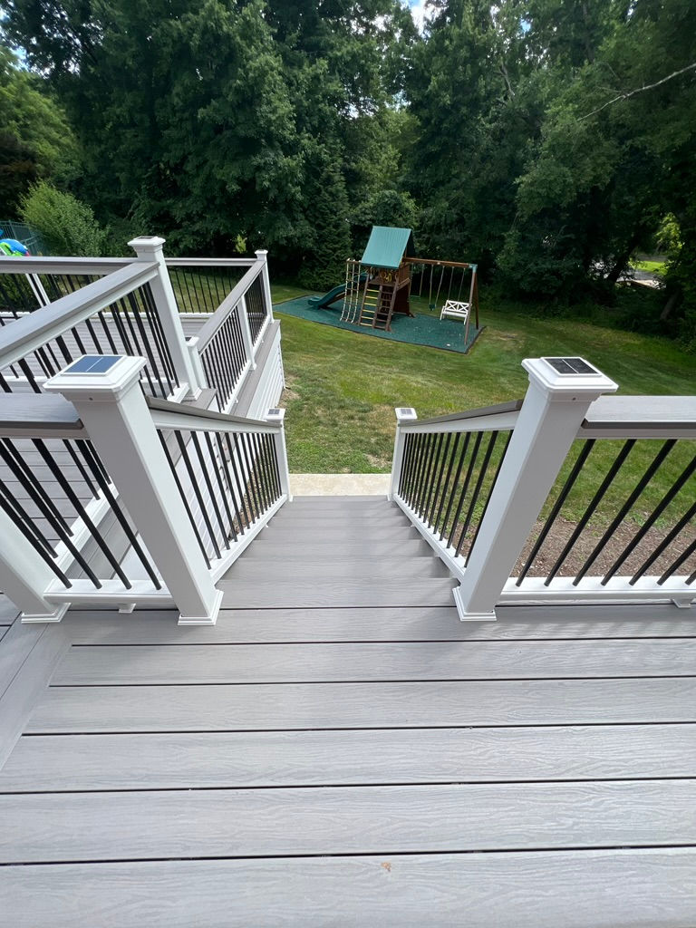 New deck construction build with moisture shield decking and Trex transcend rails with cocktails rails in Easton, CT.