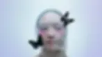 Artistic image of Asian woman with extreme pink blush a fine white veil with two butterflies 
