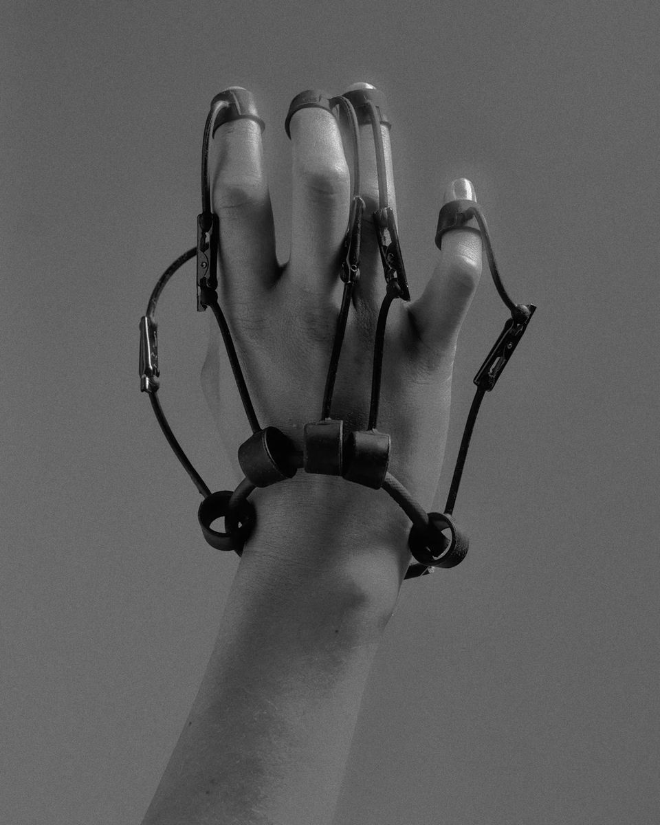 Hand wearing a black fingerless glove
