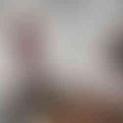 Elegant traditional interior with intricate wall moldings, antique furniture, and a contemporary art piece.