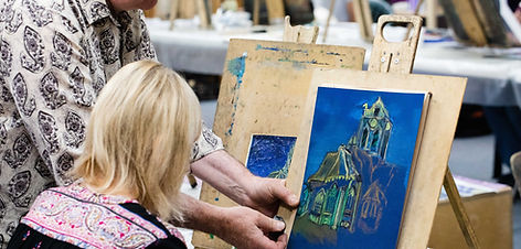 A student painting a pastel reproduction of a painting by Vincent Van Gogh