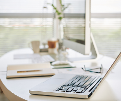 desk with laptop and notepad