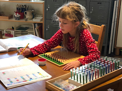 Montessori Elementary Child using materi