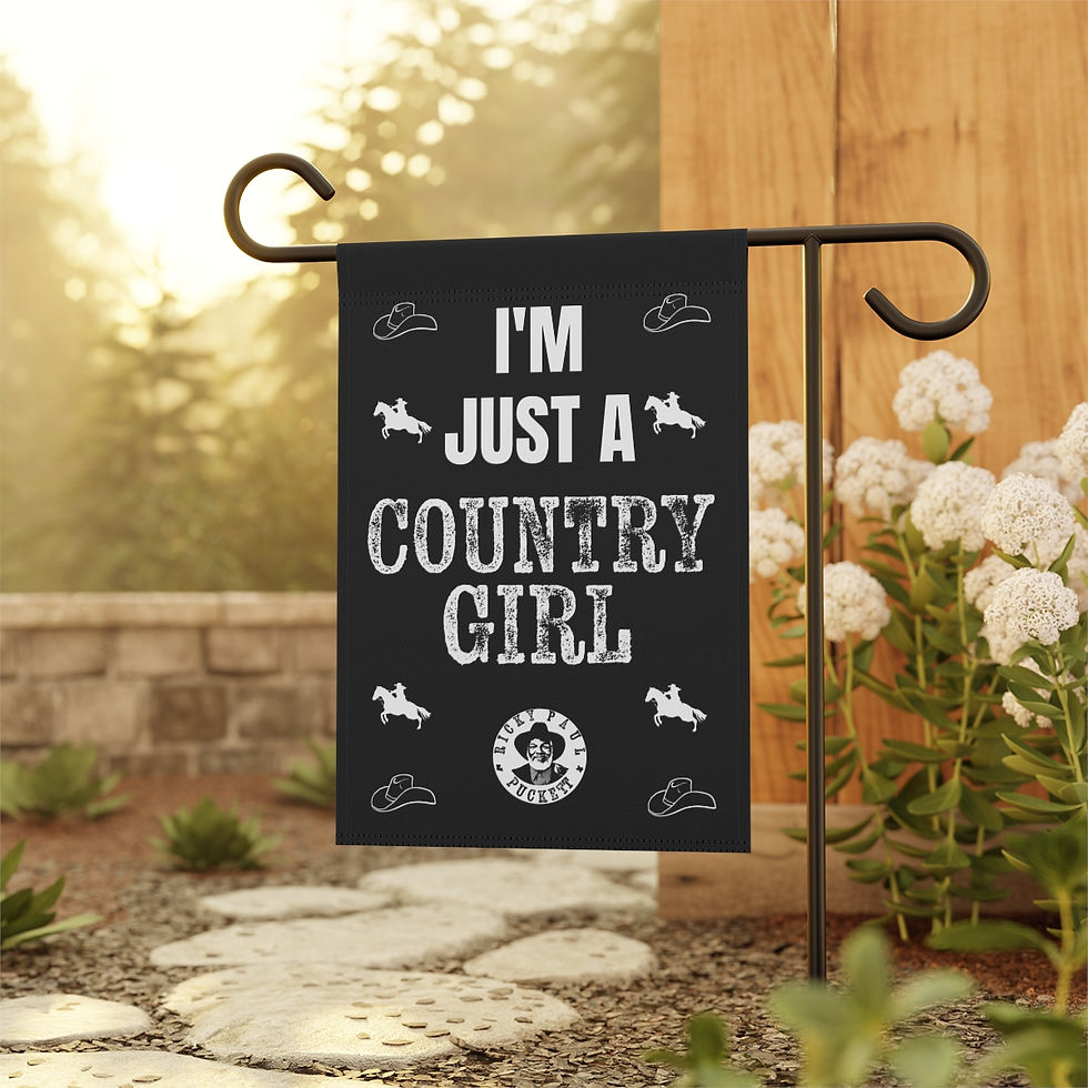Thumbnail: Black garden flag reads: I'M JUST A COUNTRY GIRL, outside in the garden.