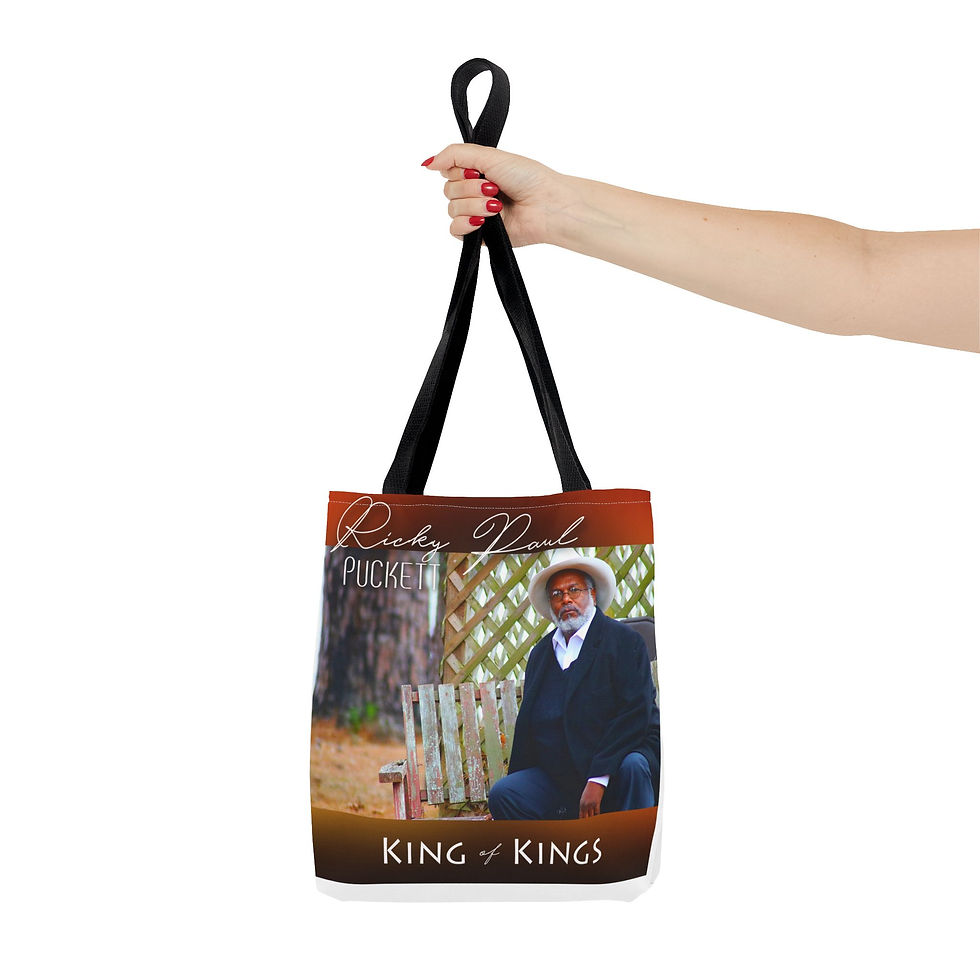 Thumbnail: Hand holding a tote bag with King and King image; brown background