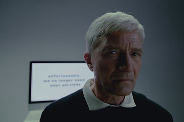 older man with screen in background