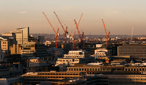 City skyline with multiple construction cranes
