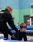 Coach Emma supporting young gymnast