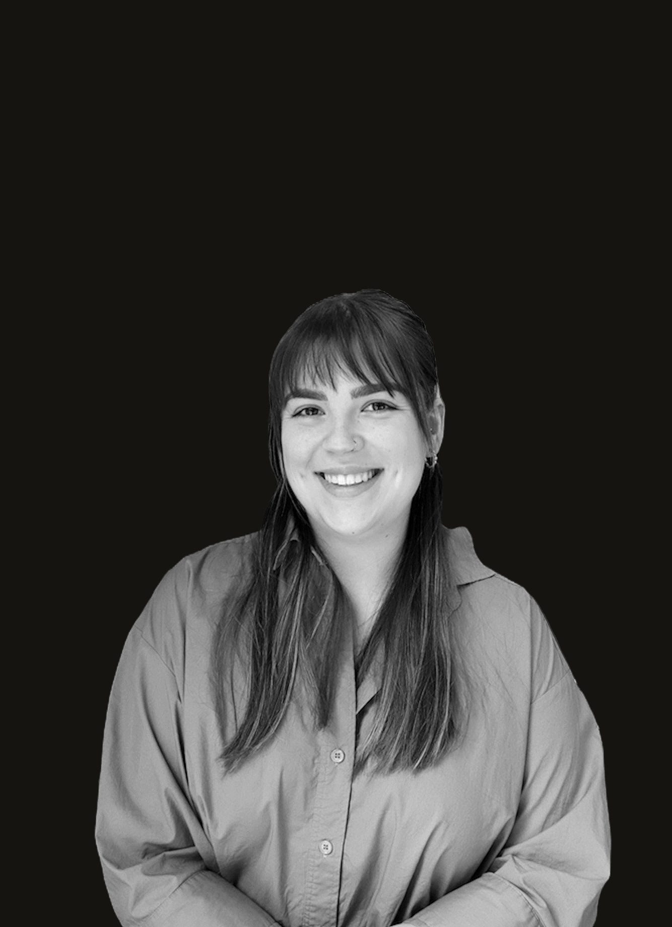 Black and white headshot photograph of Sandra Saravolac with a black background